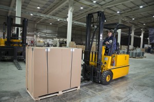Forklift operator working at warehouse